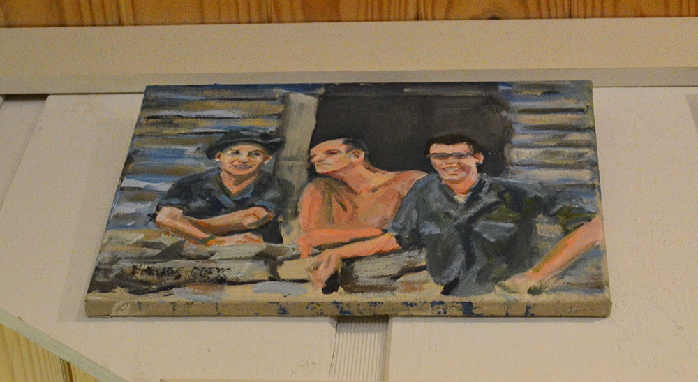 This is one of three paintings Dr. Charles Guess painted while in the army in Vietnam and his favorite. It’s of him on the left, and his fellow doctor comrades in front of their hooch in Ban Me Thuot. 