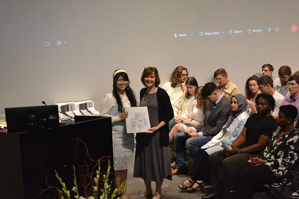 Lita Li, left, poses with Director Karen Spence on stage