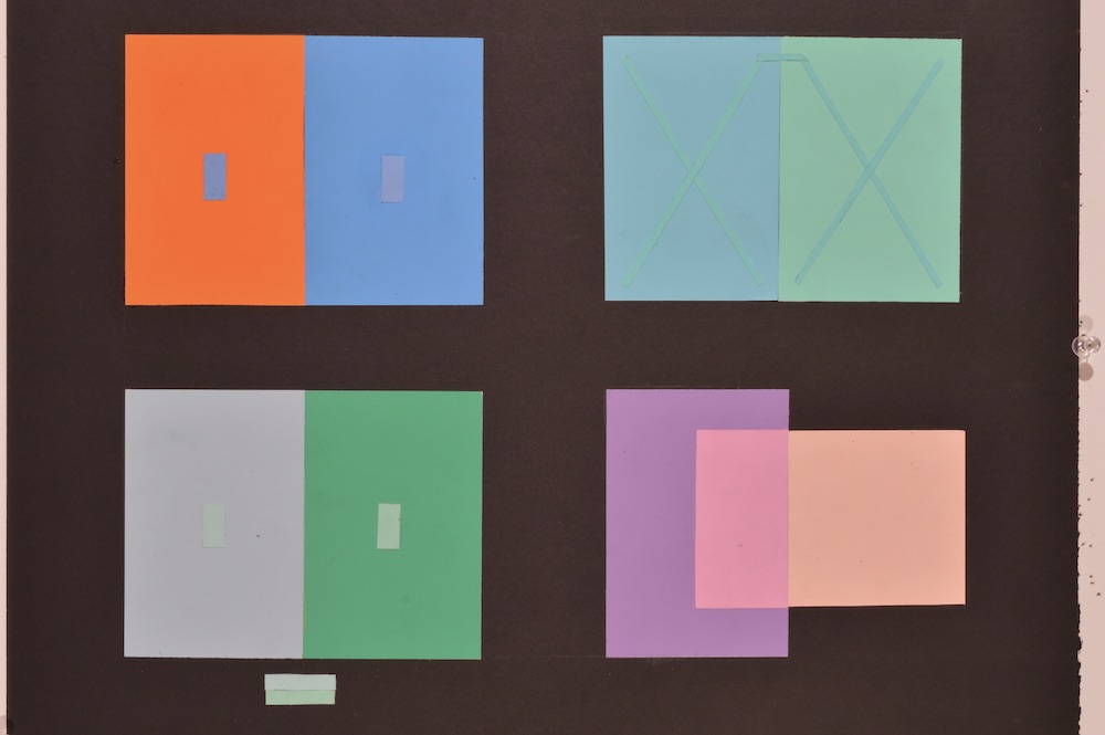 Color interaction study in which various strips of paper are set on top of color swatches, they appear to all be the same color because of the interaction with contrasting color. This interaction is seafoam green. 