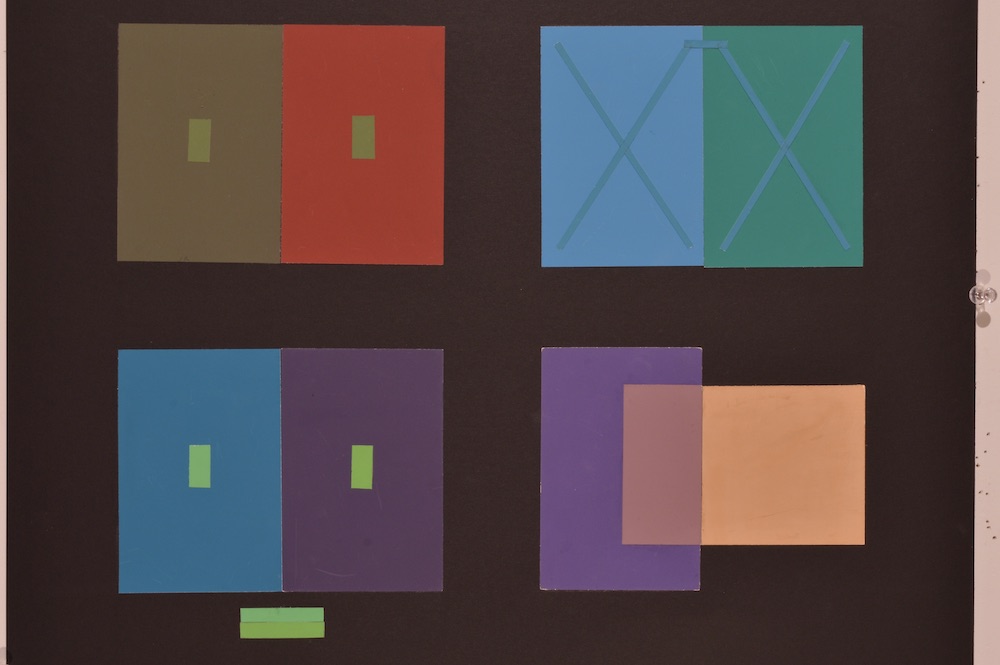 Color interaction study in which various strips of paper are set on top of color swatches, they appear to all be the same color because of the interaction with contrasting color. This interaction is lime green. 