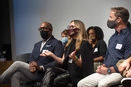 panelists talk on stage during the workshop