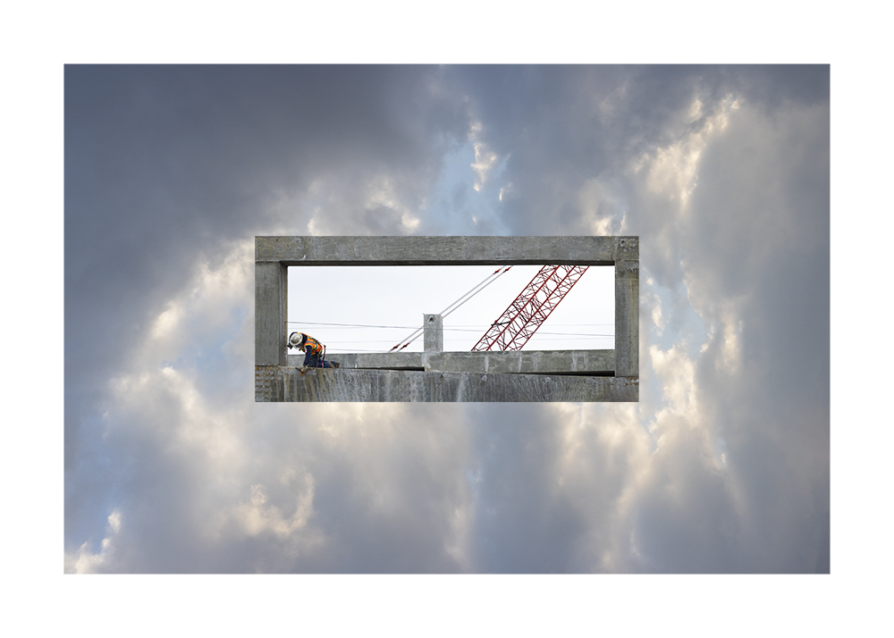 A photoshopped photograph of a person doing construction work in the sky. 