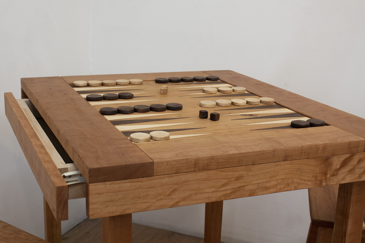 A simple table constructed with cherry wood. The center contains an inlaid backgammon board – constructed from cherry, maple, and walnut.