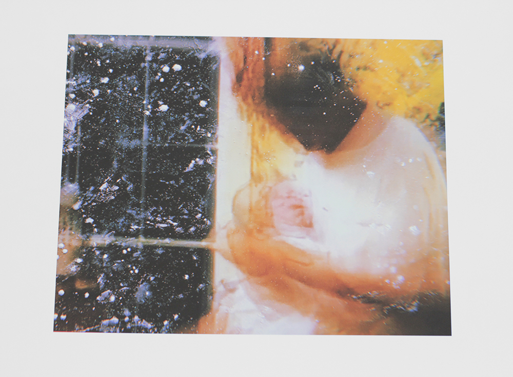A colorful hard to read image of a woman holding a baby by a window