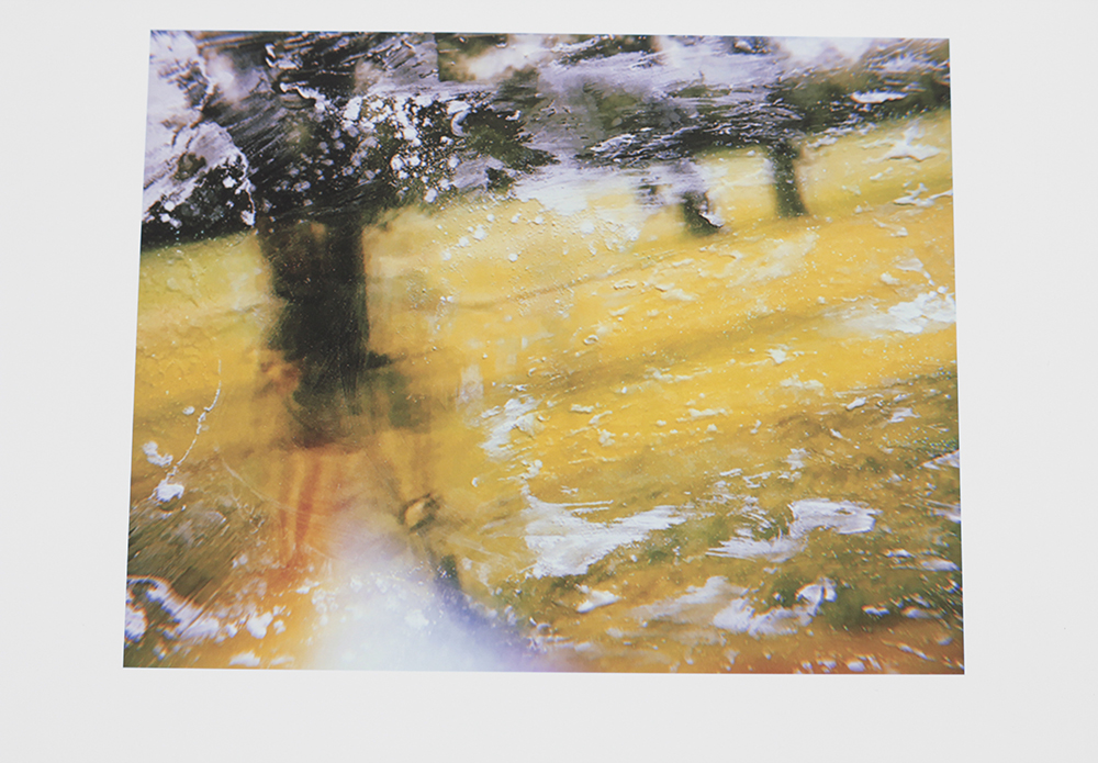 A photograph that seems to be old, very hard to read. seems to be a Child running in a field