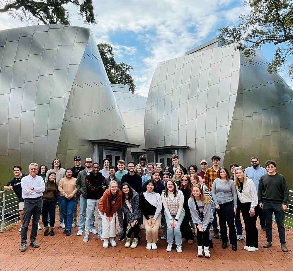 MSU Architecture students and faculty gathered in front of metal museum sculpture