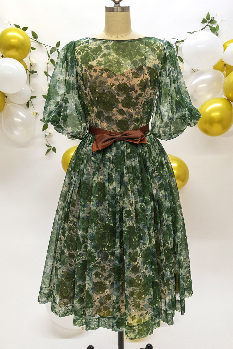1950s green floral print dress with full skirt and brown silk bow belt.