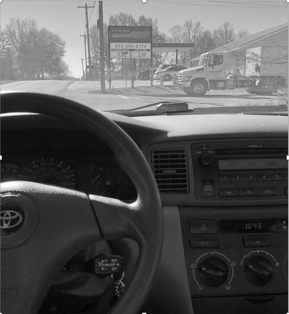 an image of a gas station from the inside of a car.