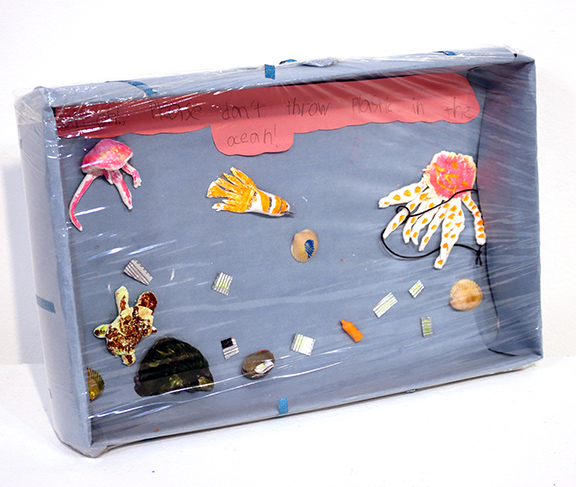 Shoe box filled with sea creatures made from paper and clay.