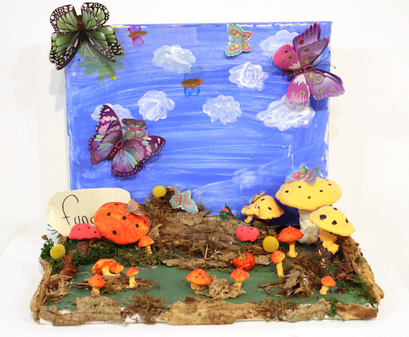 A diorama of butterflies and mushrooms