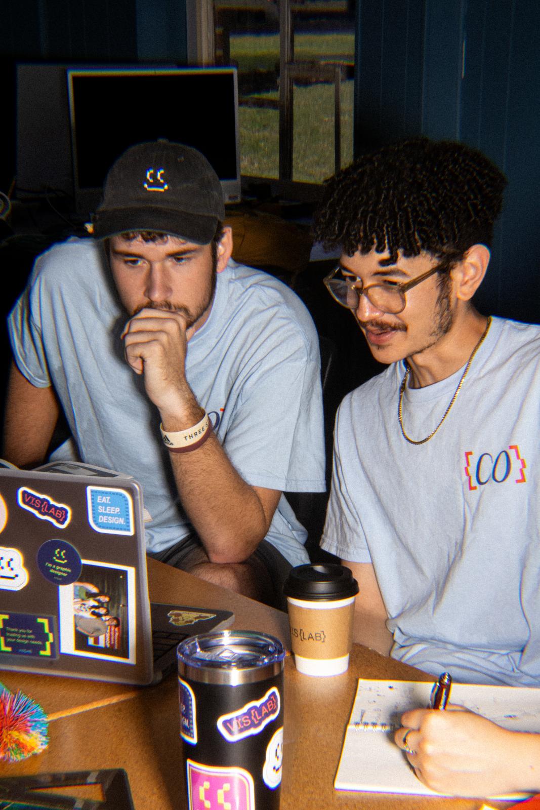 From left: Senor graphic design majors Thomas Bongiolatti of Collierville, Tennessee, and Daniel Hardy of Biloxi work in the Visual Communication Collaborative Laboratory, which targets in-state clients with a focus on culture and the arts, archiving and community support. (Photo submitted)
