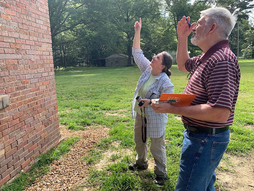 Charlyn King, left, and Tommy King look at the Old Salem School exterior in Macon, Mississippi