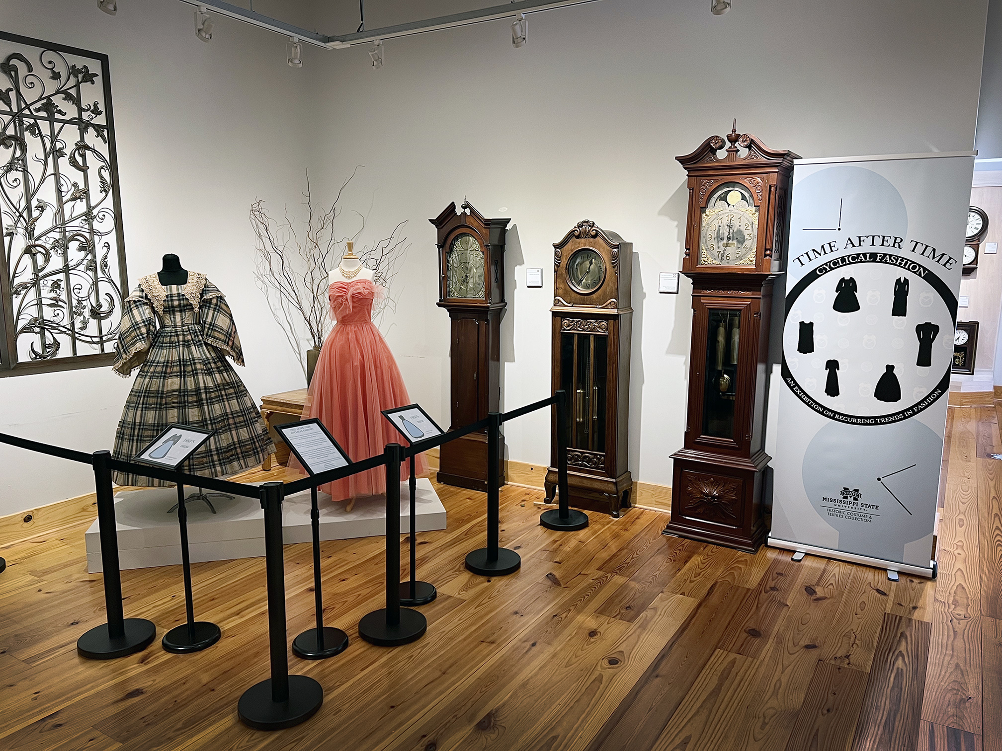 Two dresses on display in a clock museum.