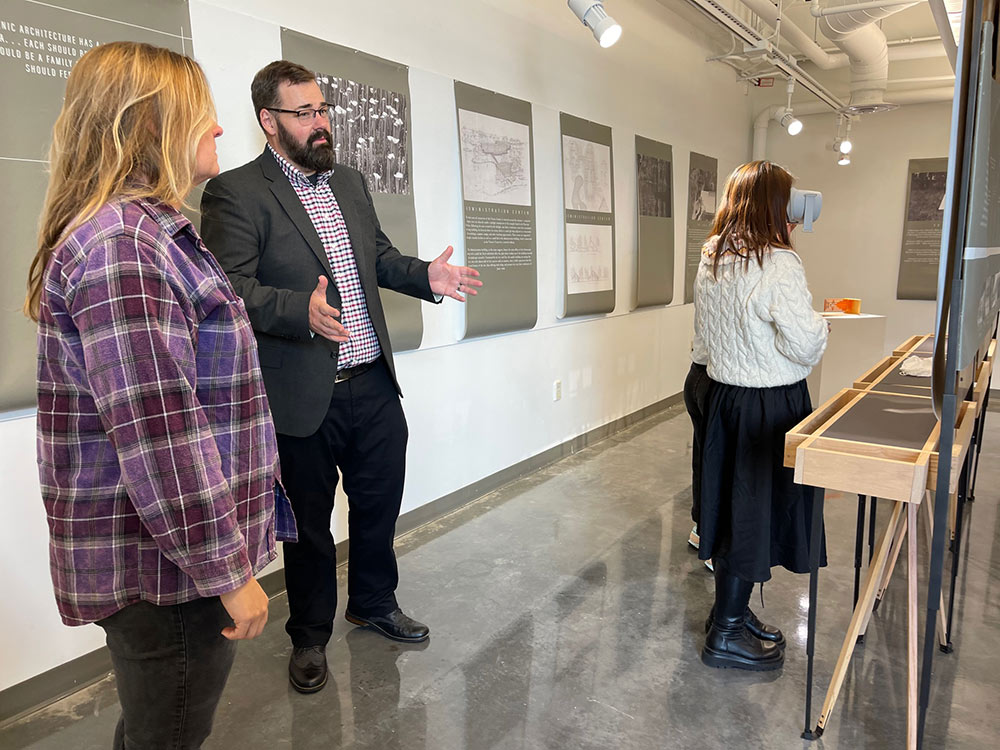 Herrmann, right, talks with someone at his exhibition