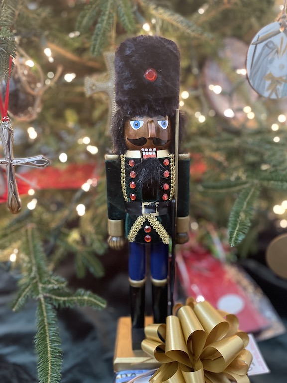 Nutcracker ornament hanging on a Christmas tree