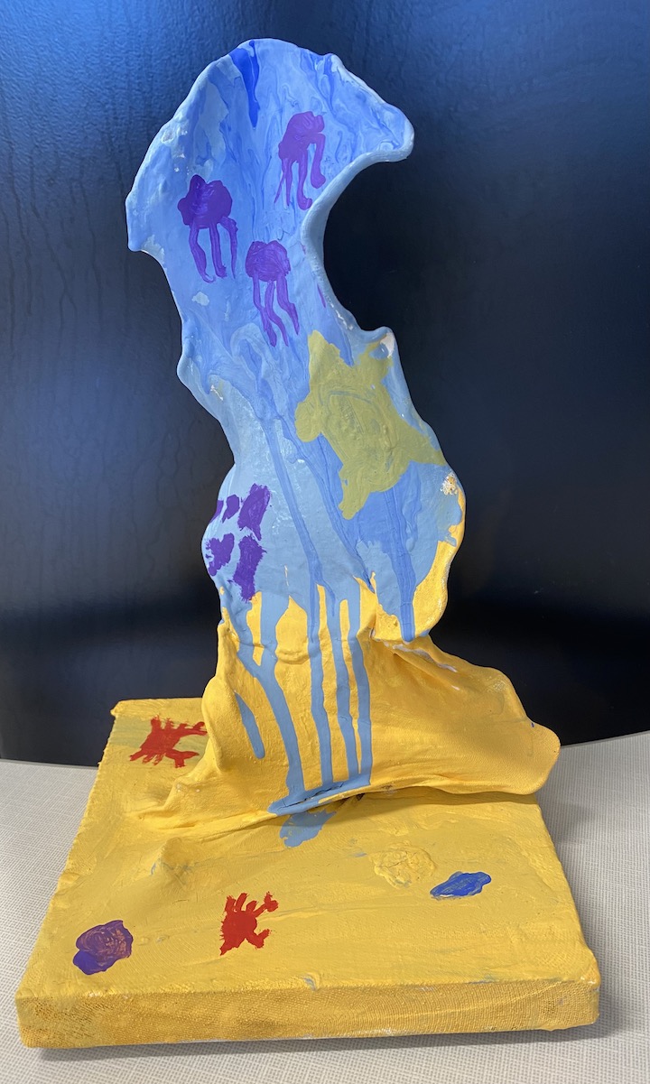 Non-Representative Sculpture painted with sea life and sand on it.