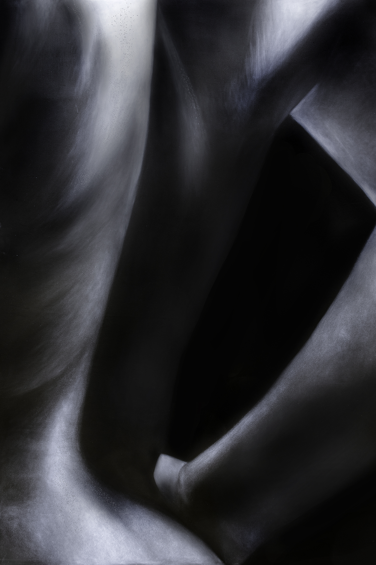 A closely cropped image of a figure’s back and arm, hand on hip, surrounded by harsh shadows. Features skin texture and underlying muscle structures.
