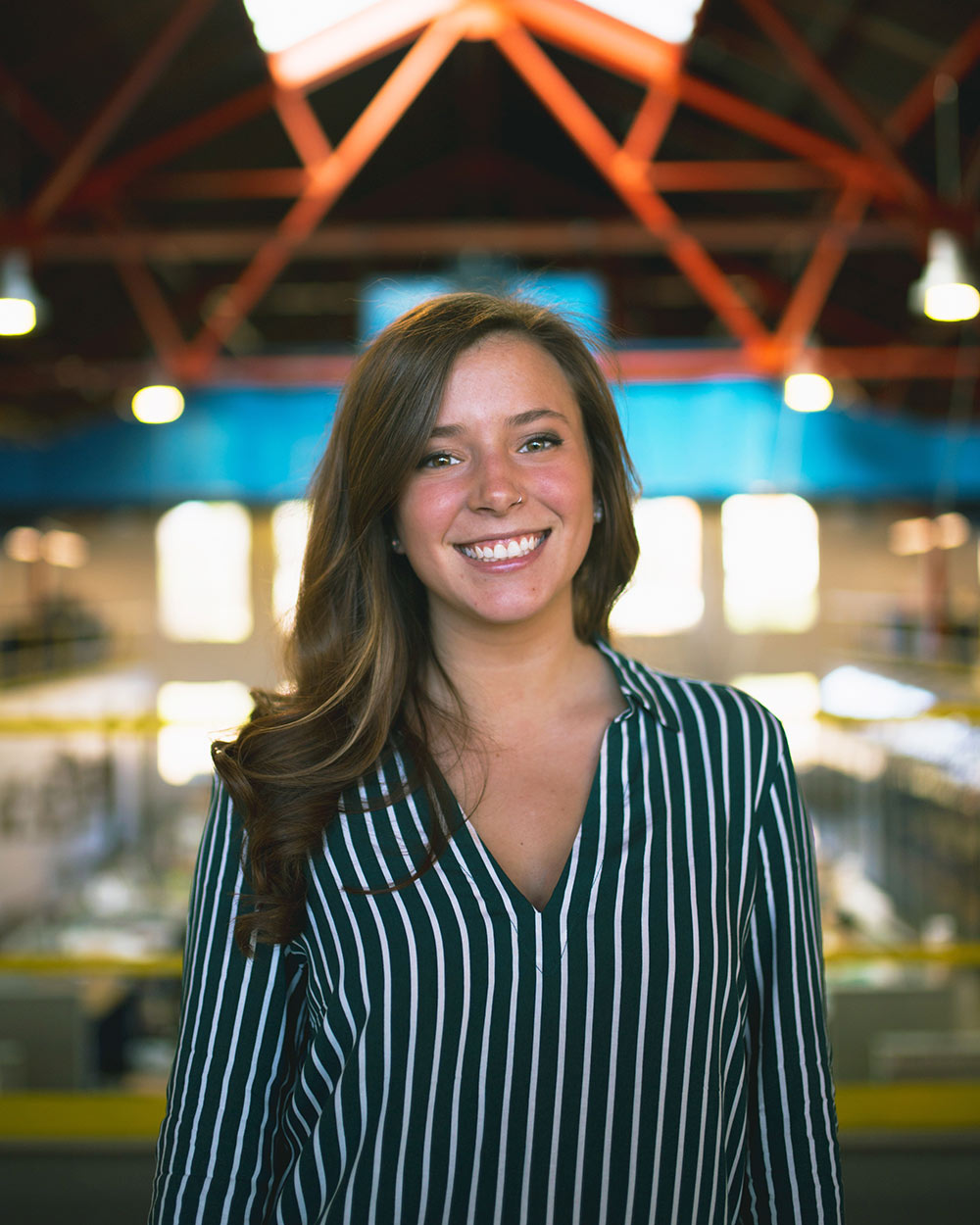 Kenzie Johnson poses with Giles Hall Barn in background