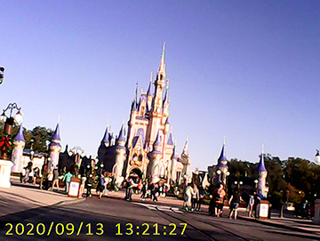 Color photograph of a castle and blue sky.