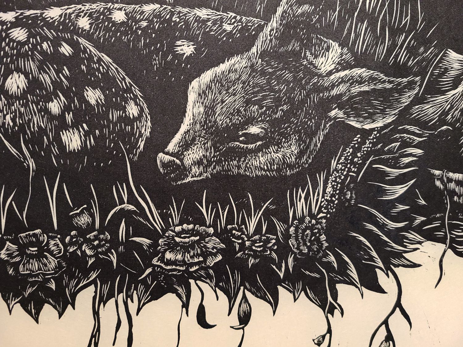 Close up of a print with a deer laying in a bed of flowers.