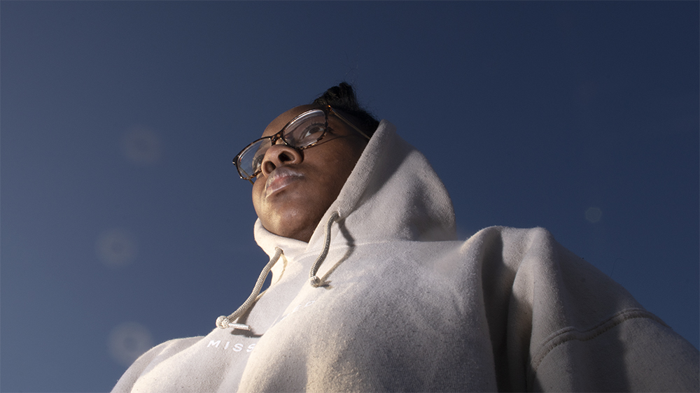 A dog eyes view photograph of a person in a gray hoodie