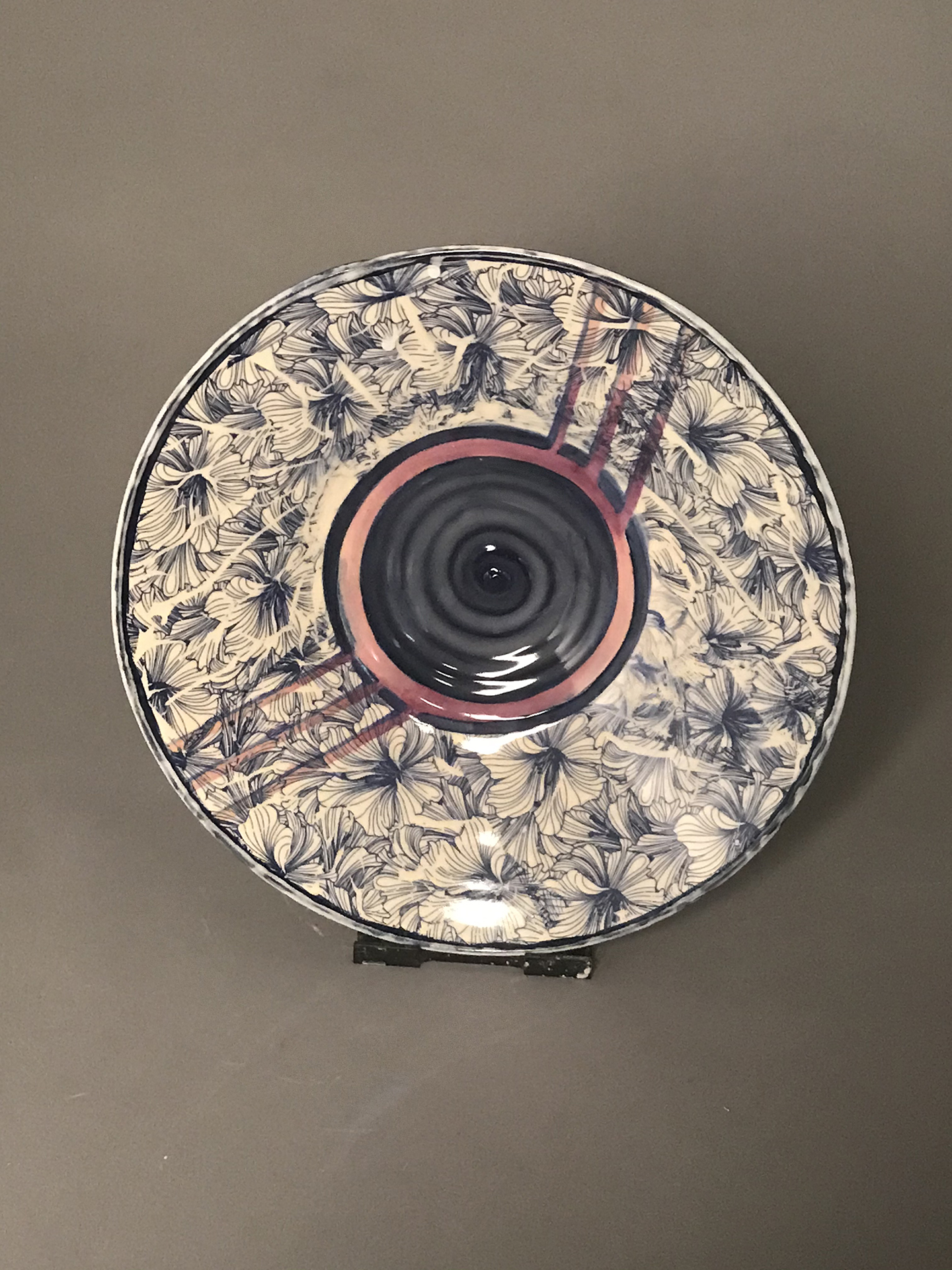 white and blue Ceramic plate with blue hibiscus flower petals on the outer edges.