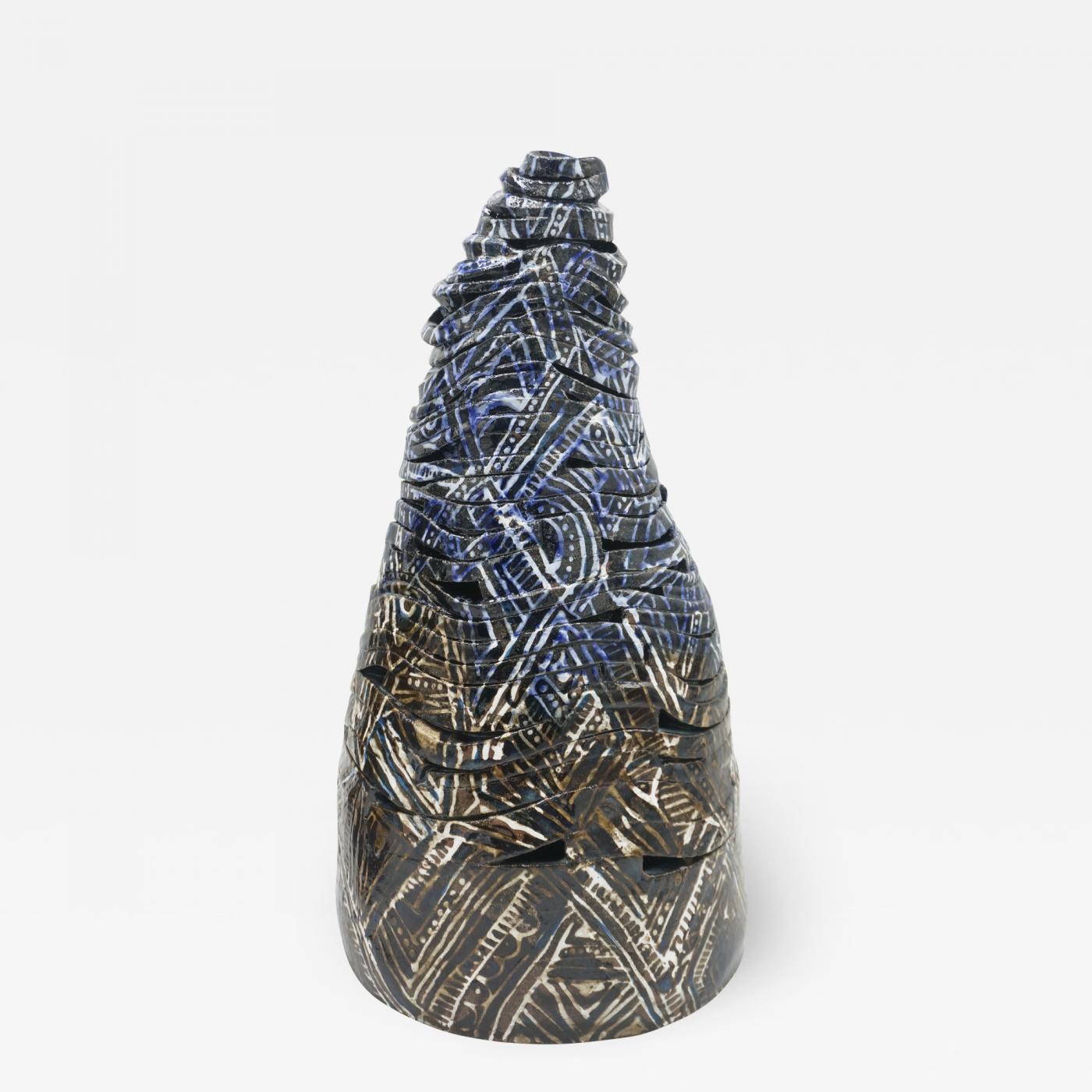 Cone shaped ceramic sculpture in the form of spiraling ribbon or cloth patterned with brown and blue motifs.