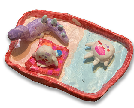 Clay figures laying on a platter.
