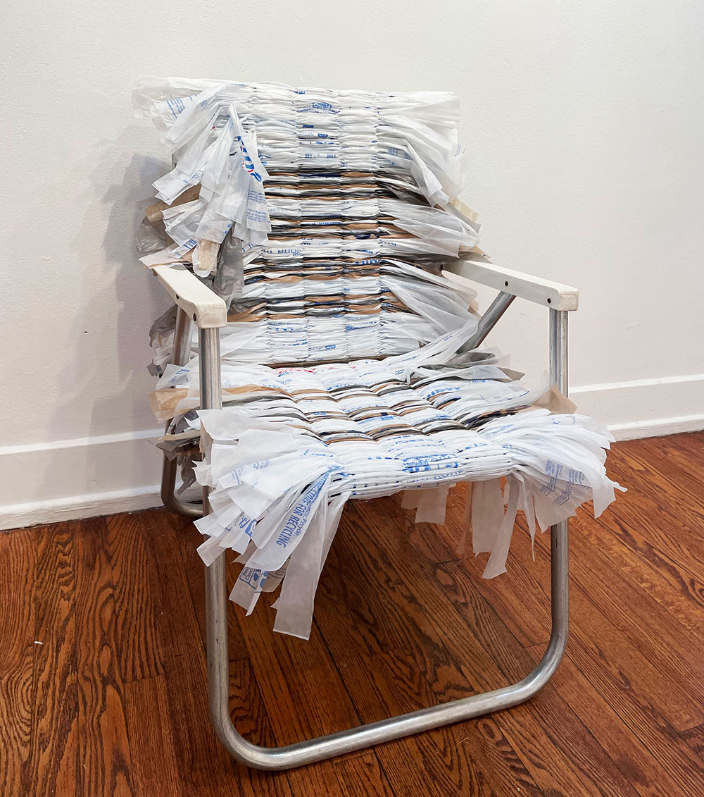 A lawn chair taken apart and resown together by plastic grocery bags.