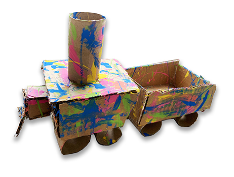 Sculpture of a train made with painted cardboard boxes and paper towel rolls.