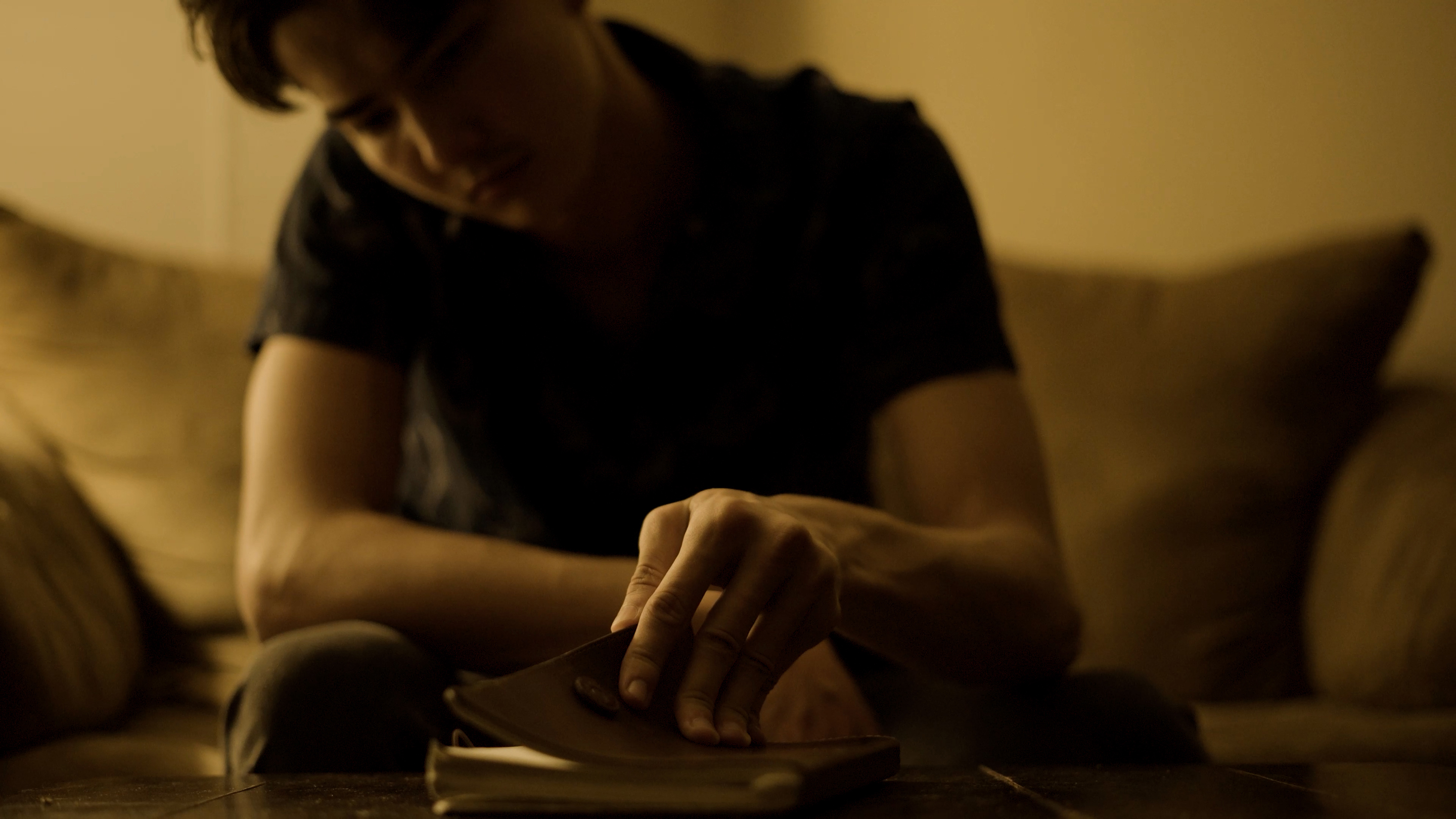 Photograph of a person sitting on a couch.