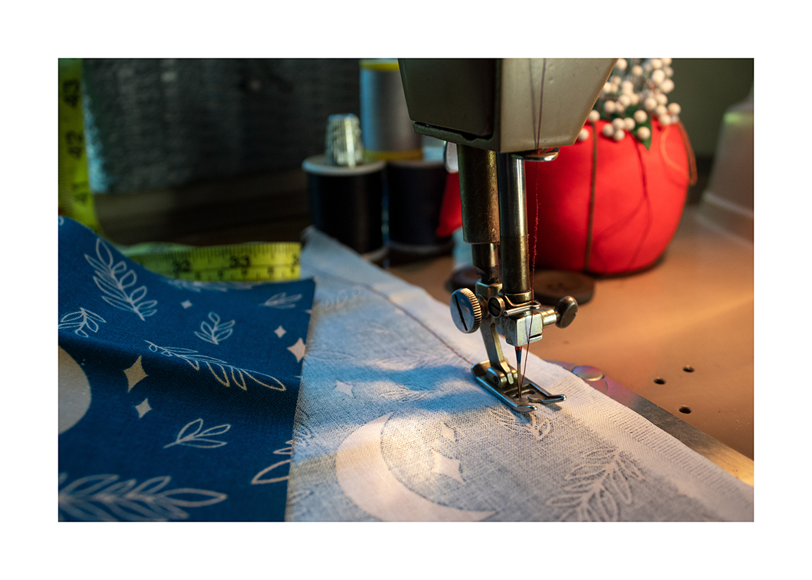 Photograph of a sewing machine stitching fabric.