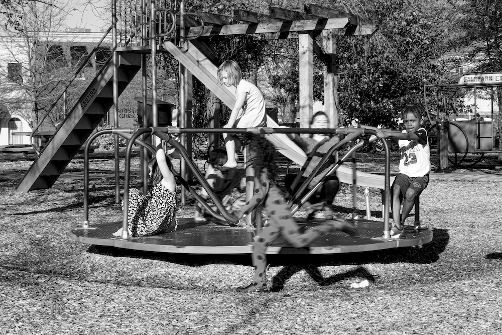 Photograph of several children playing on playground equipment