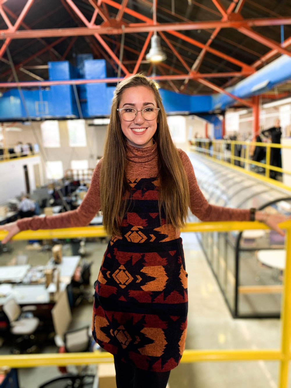 Hannah Strider poses on breezeway of Barn in Giles Hall