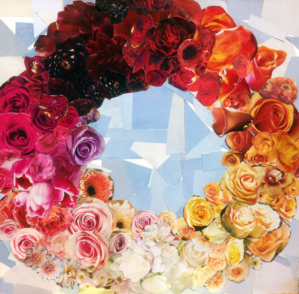 colorful wreath of cutout roses in various colors of red, orange, yellow, pink on light blue background