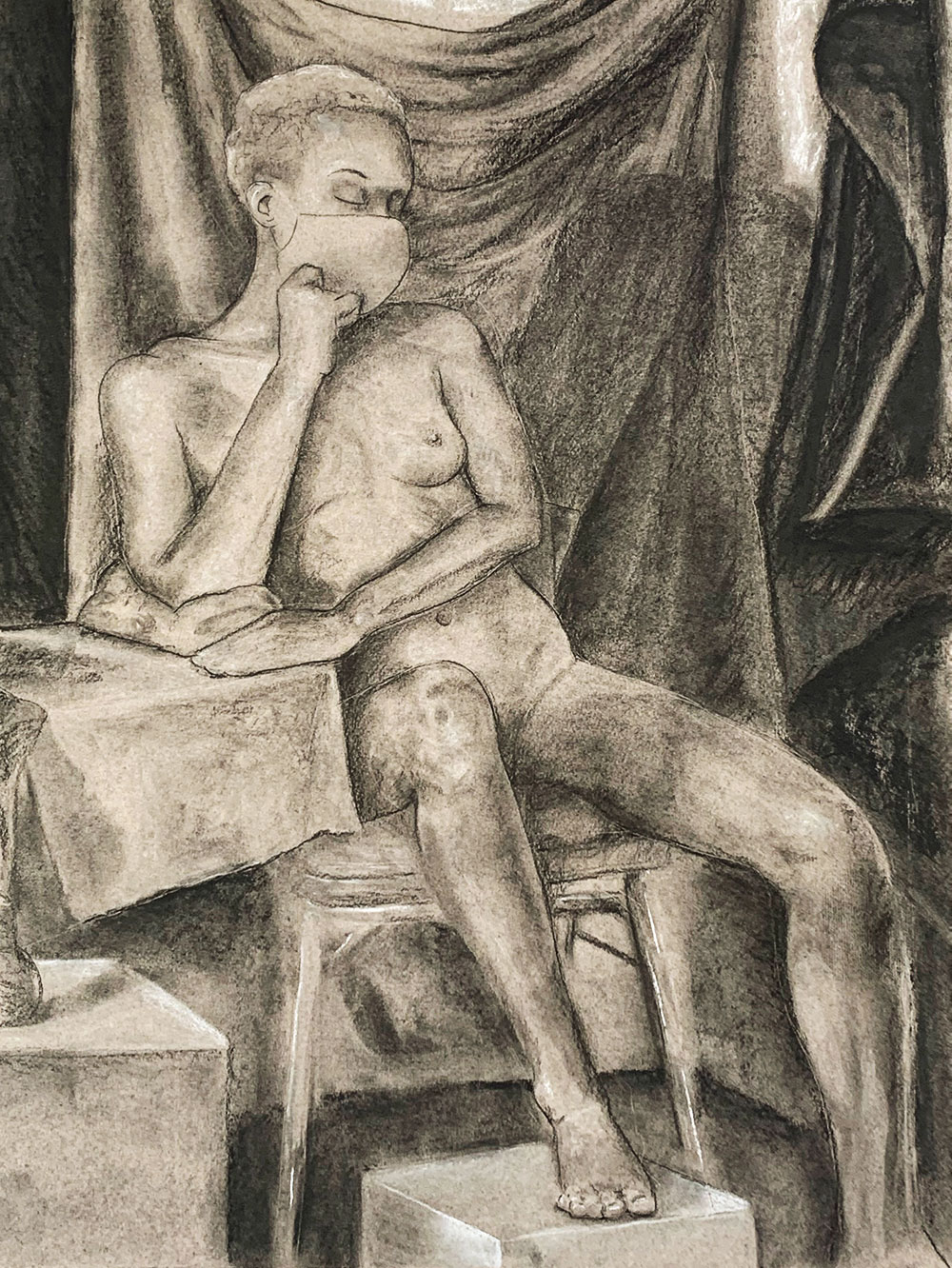 A naked woman model is drawn using the heightened value technique- applying light and dark material to a gray toned surface. 