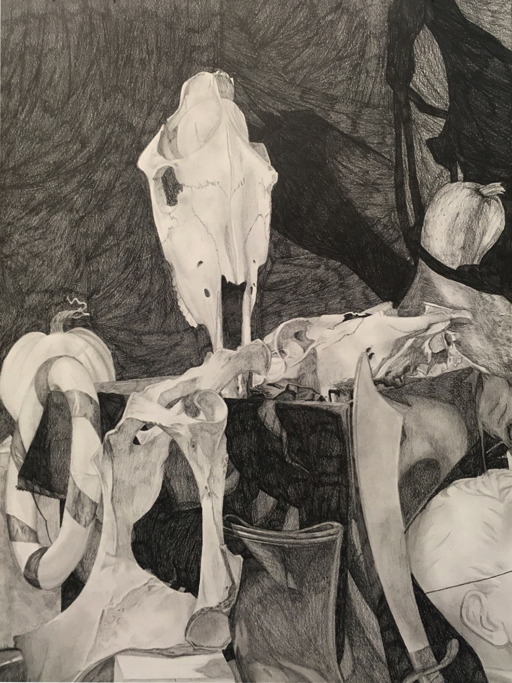 Still life drawing out of charcoal - specifically focused in on a skull, bones, a sword.