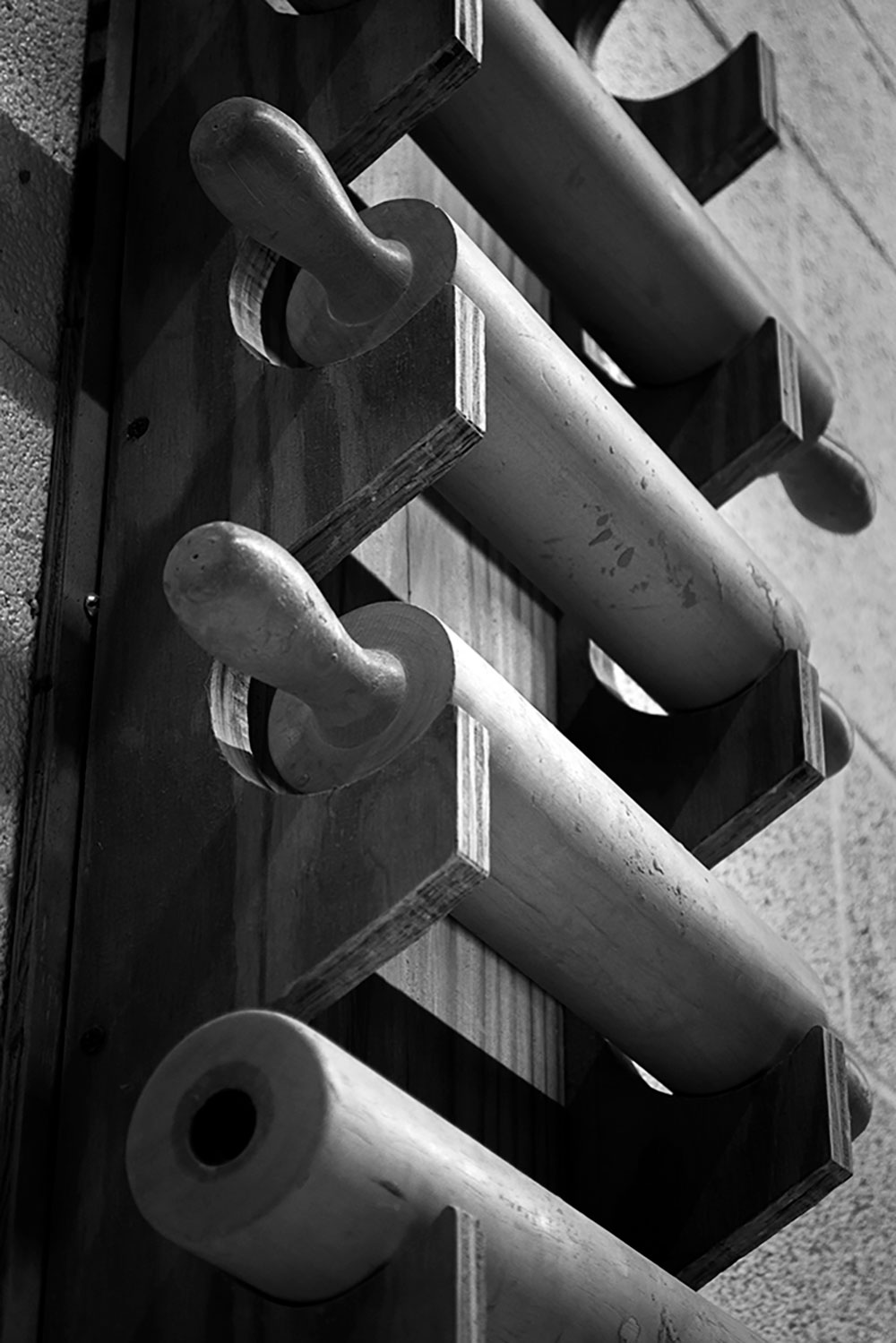 A black and white photographed image of rolling pins.