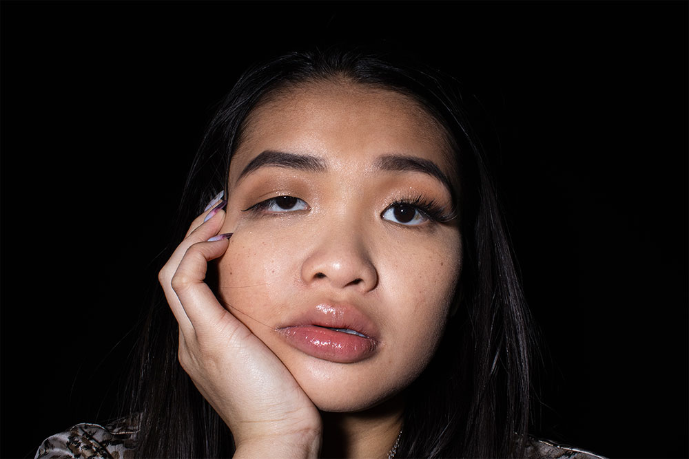 A photographed image of a girl with make up on.