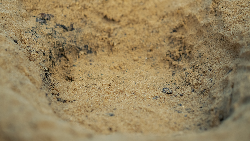 A photograph of a small circle in sand.