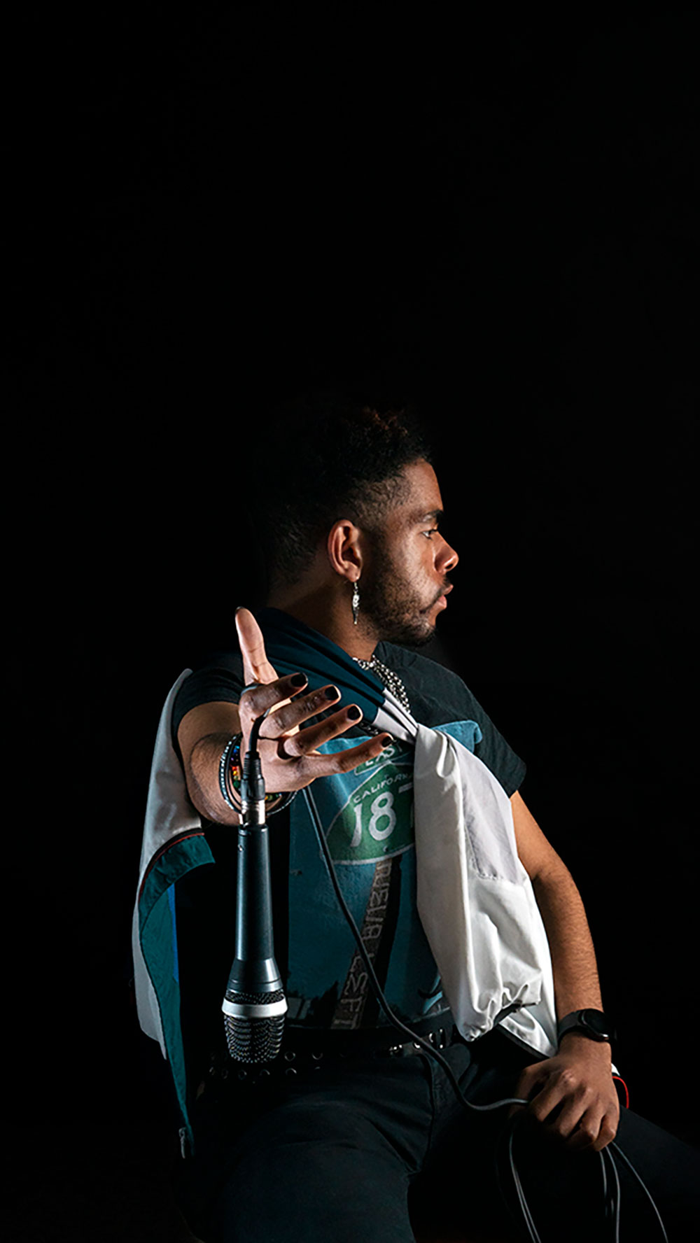 A photographed image of man holding a microphone.