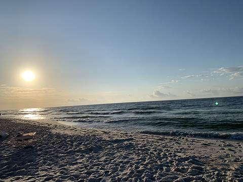 Photograph of a beach at sunrise.