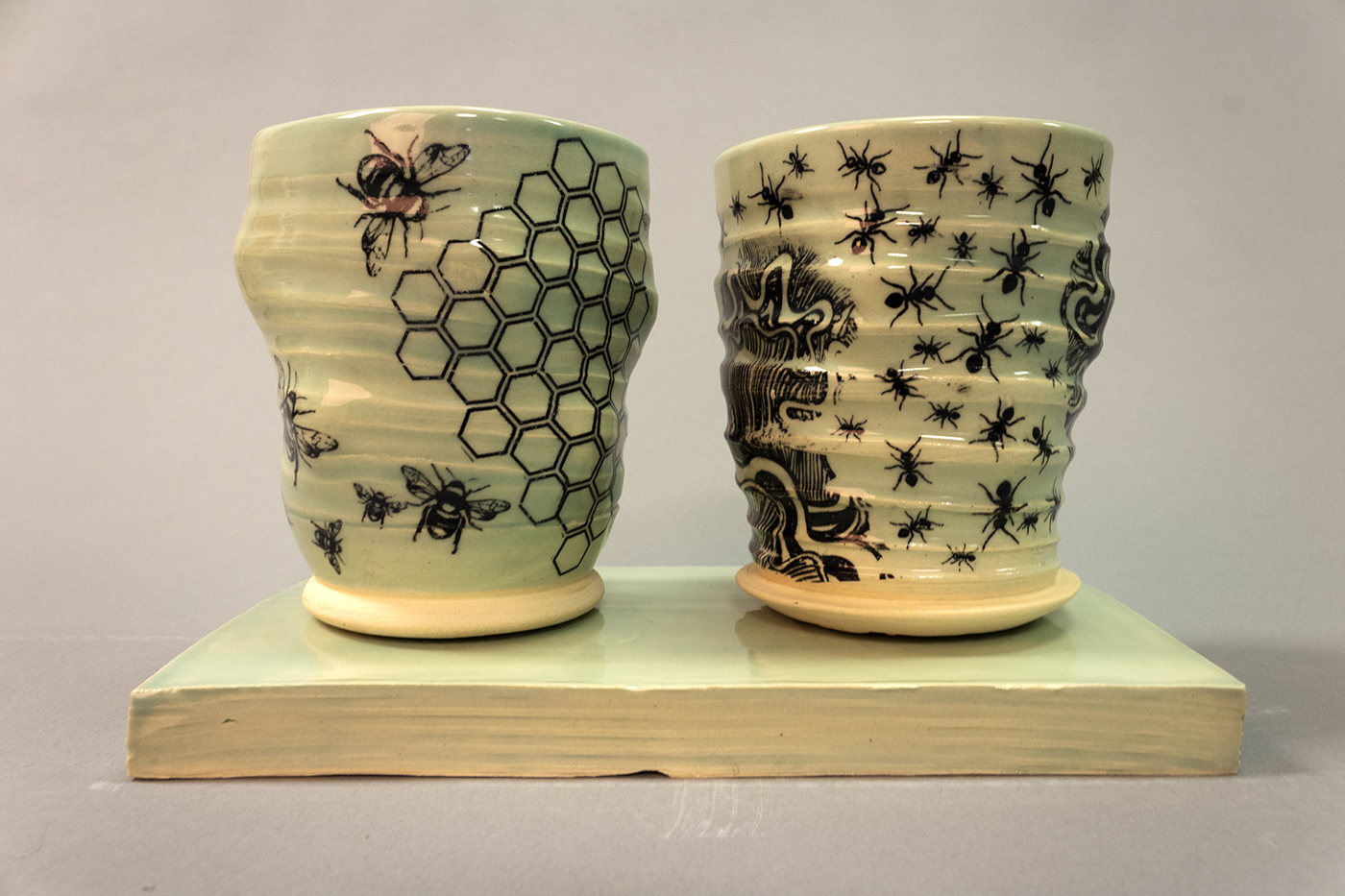 Two aqua colored cups sitting on a coordinating tray.