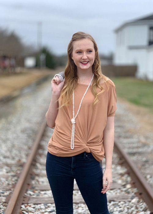 Olivia Tess Frazier poses on railroad track