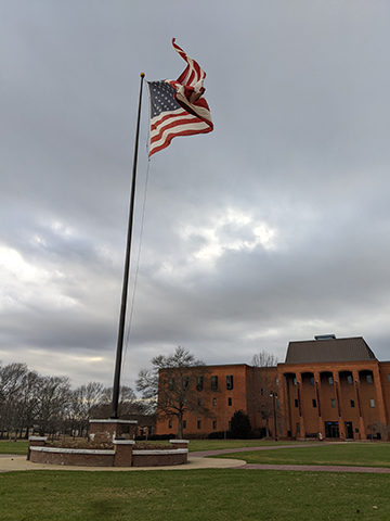 Photography of the American flag on a pole.