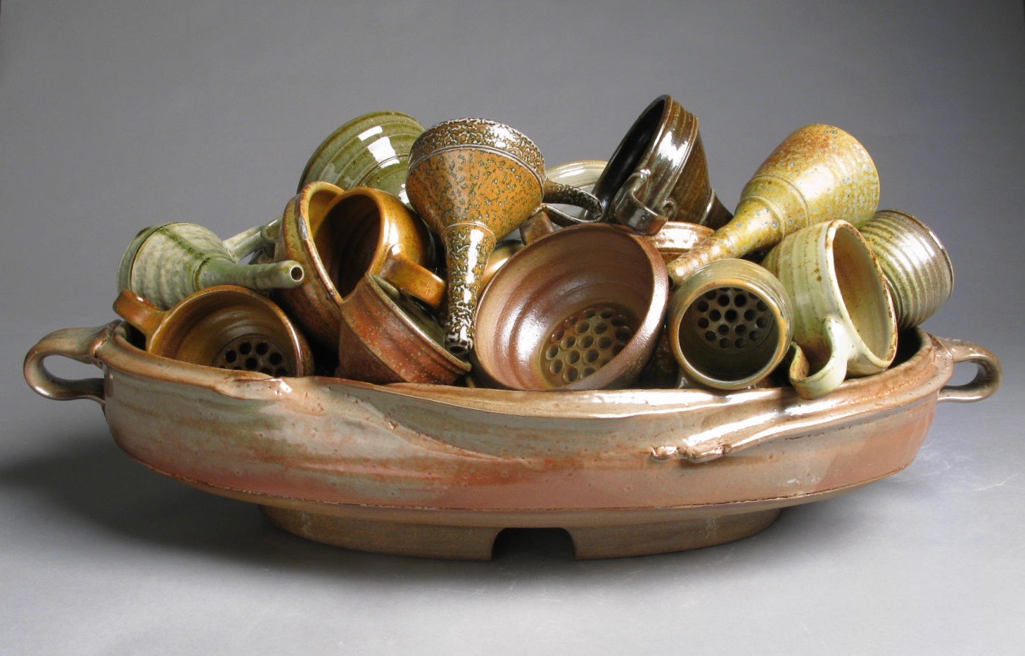 Ceramic bowl filled with many ceramic funnels.