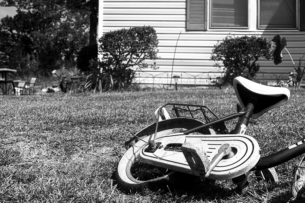 black and white photo by MSU photo student Maurissa Shumpert of old bike in yard