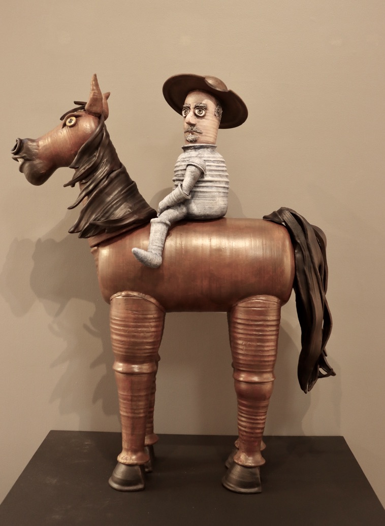 Ceramic knight sitting on brown horse