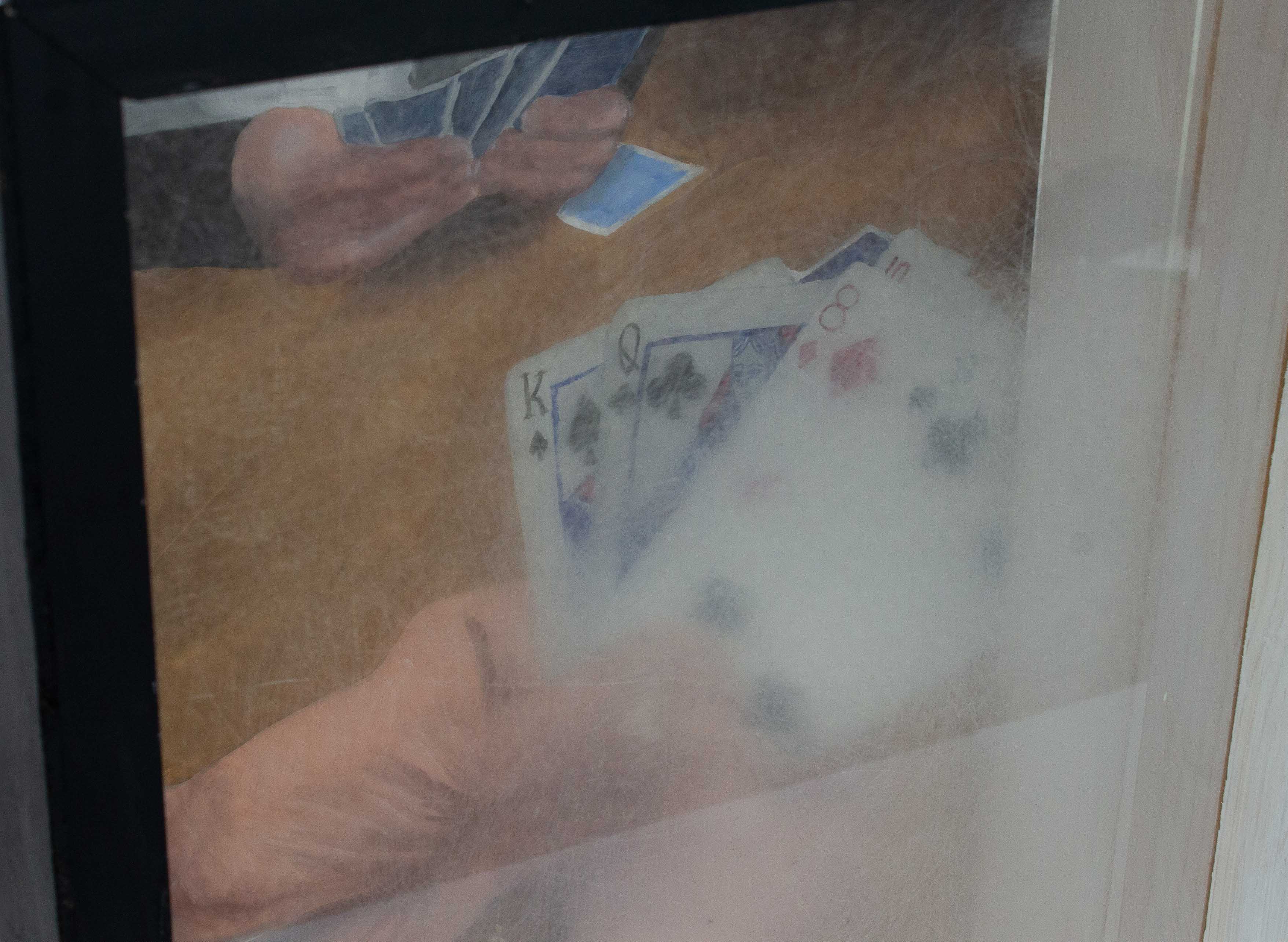 A detail image of the top left corner of the piece. A box with a painting in the back and treated plexiglass panels interfering with the view of the painting. The painting shows an older person’s hands holding playing cards. There is another person sat across from the hands playing the game as well. Just the back panel of plexiglass is in front of the painting. Up close the treatment of the plexiglass can be seen more, it is very rough, scratched, and blurry. 