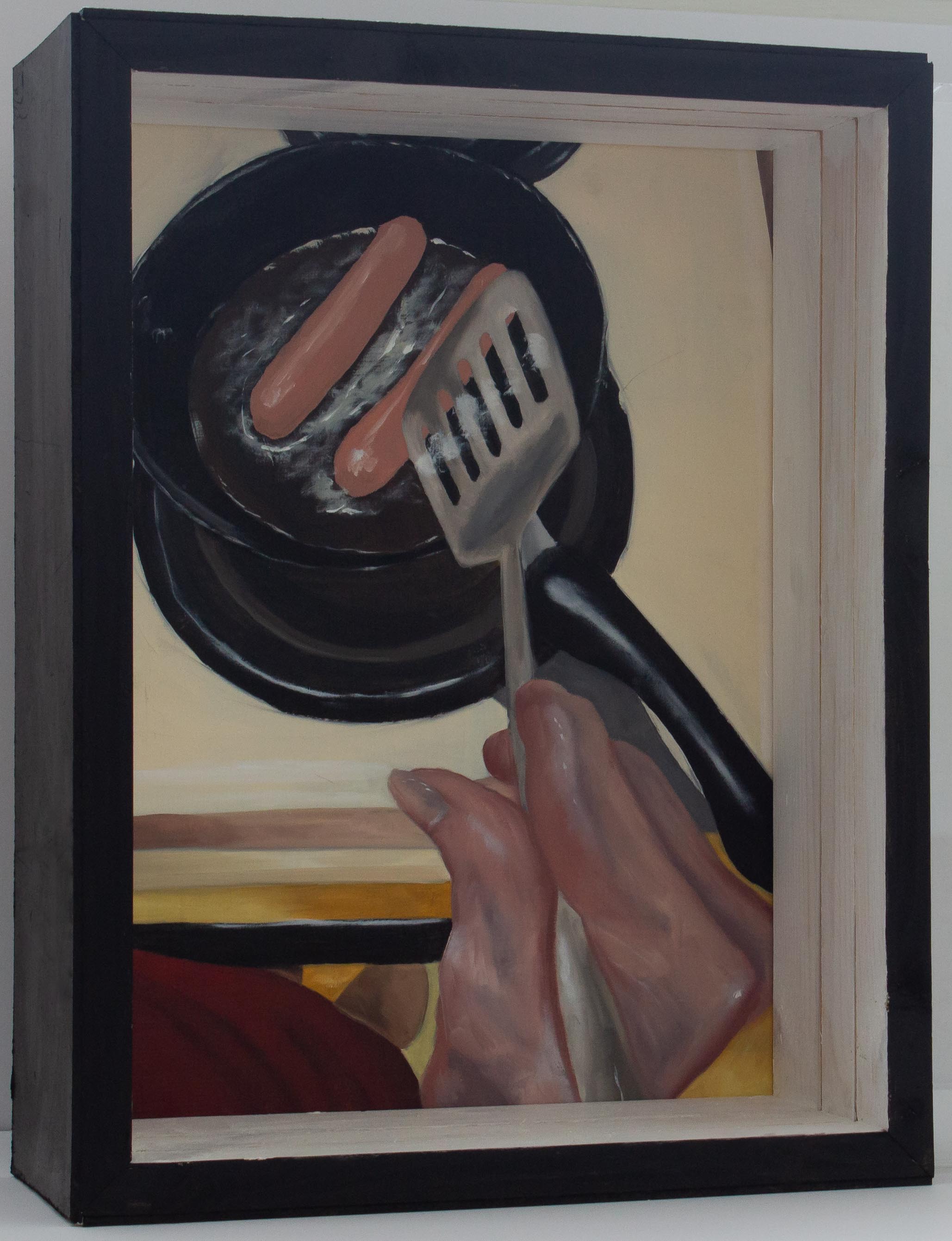 A box with a painting in the back and treated plexiglass panels interfering with the view of the painting. The painting shows an older person’s hand as they cook two hotdogs on a skillet. The person is holding a spatula. They are wearing a red shirt. The stove top surrounding the eye being used is visible. Both panels are slid out of the box. The painting is no longer obstructed by the plexiglass. The hand in the foreground is wrinkly and the fingers are crooked due to arthritis. The painting has an overall warm color pallet.